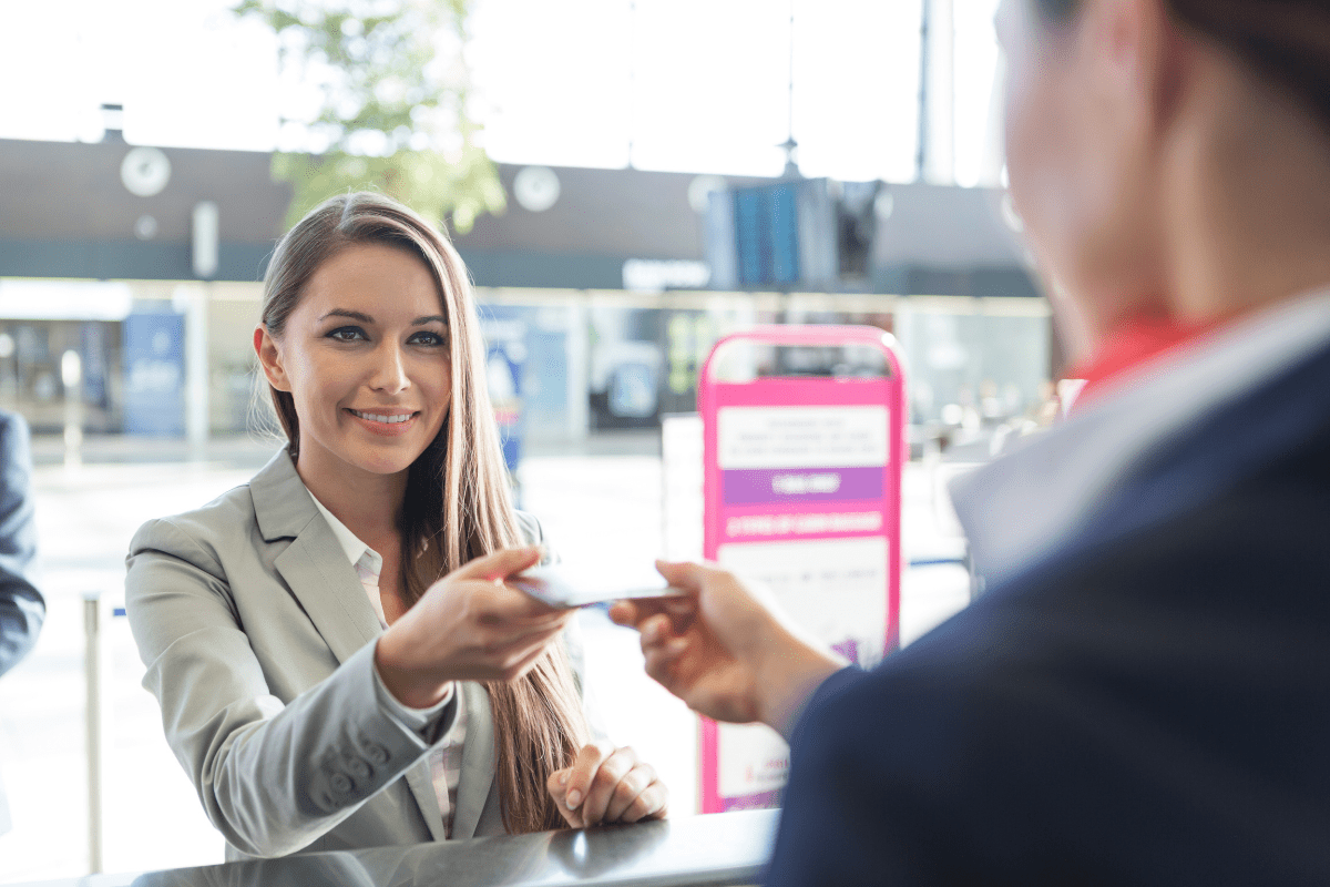 woman at airport presenting biometric passport
