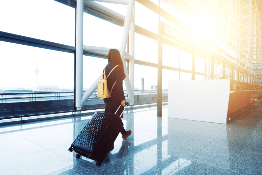 woman walking through airport with UK passport